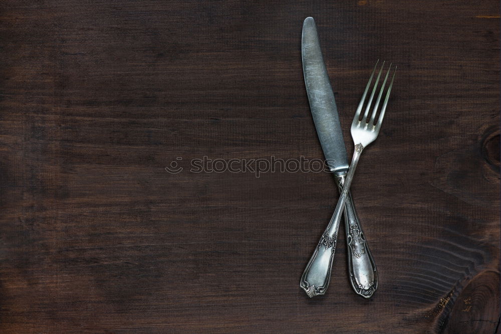 Similar – Spoon and fork on the plate framed with spices