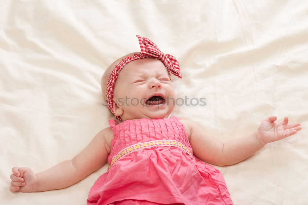 Similar – Baby girl in a bed with toys around.