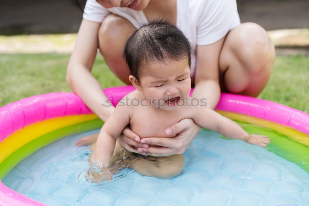 Similar – Teenage girl with her little sister spending time together in the swimming pool in a garden enjoy eating ice cream on a summer sunny day. Family quality time