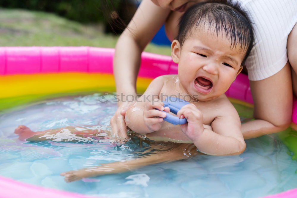 Similar – Teenage girl with her little sister spending time together in the swimming pool in a garden enjoy eating ice cream on a summer sunny day. Family quality time