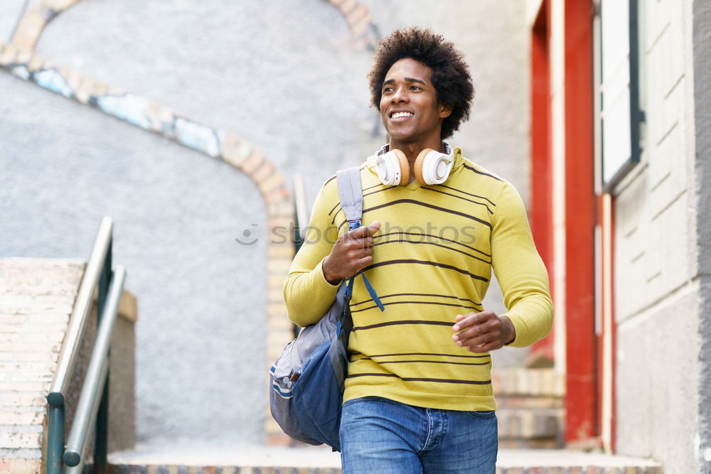 Similar – Young black man walking smiling down the street.