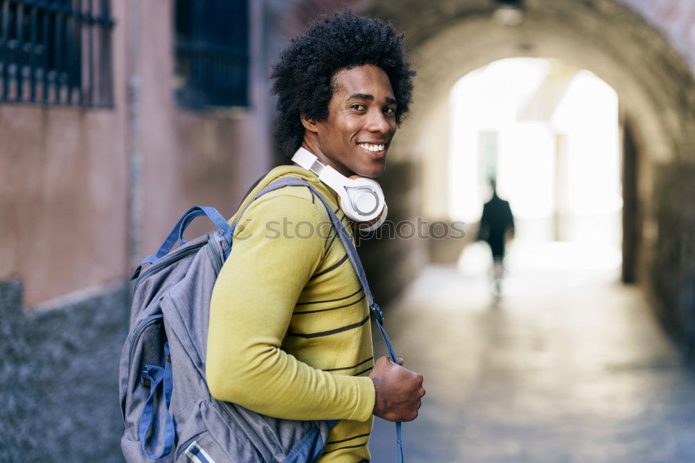 Similar – Young black man walking smiling down the street.