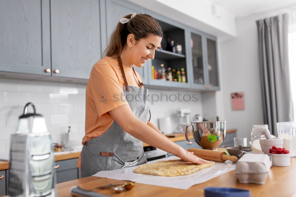 Similar – Image, Stock Photo Young couple cooking. Man and woman in their kitchen