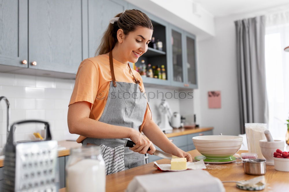 Similar – Image, Stock Photo Young couple cooking. Man and woman in their kitchen