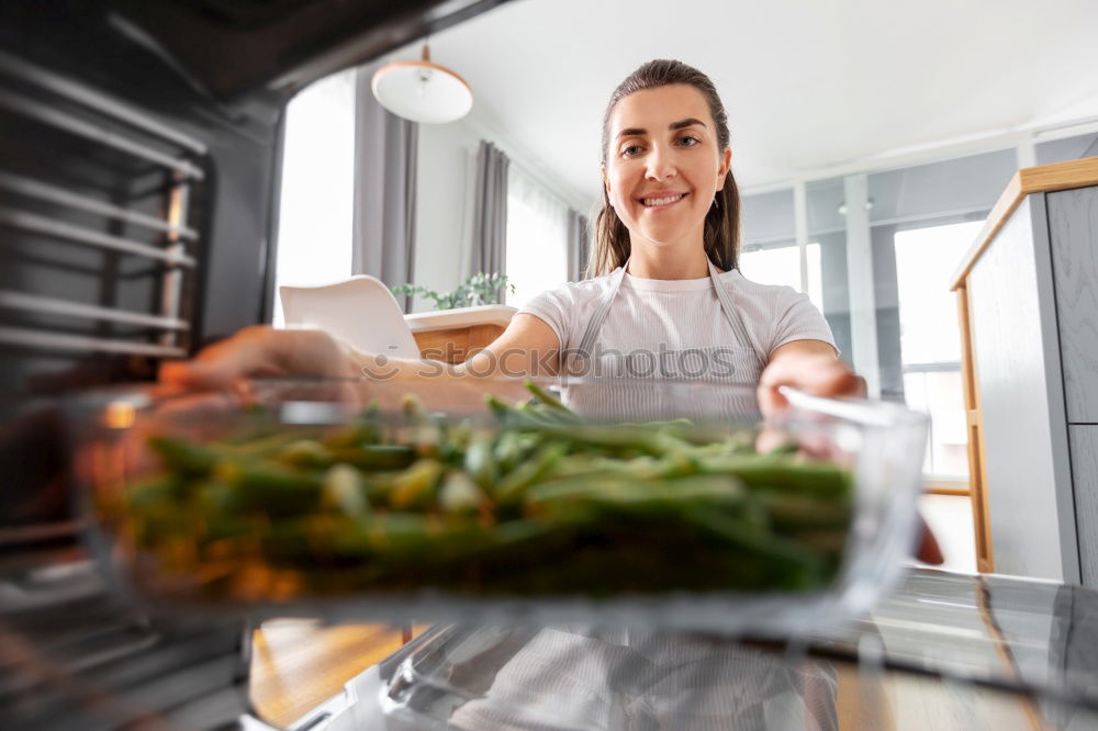 Similar – Image, Stock Photo Young couple cooking. Man and woman in their kitchen