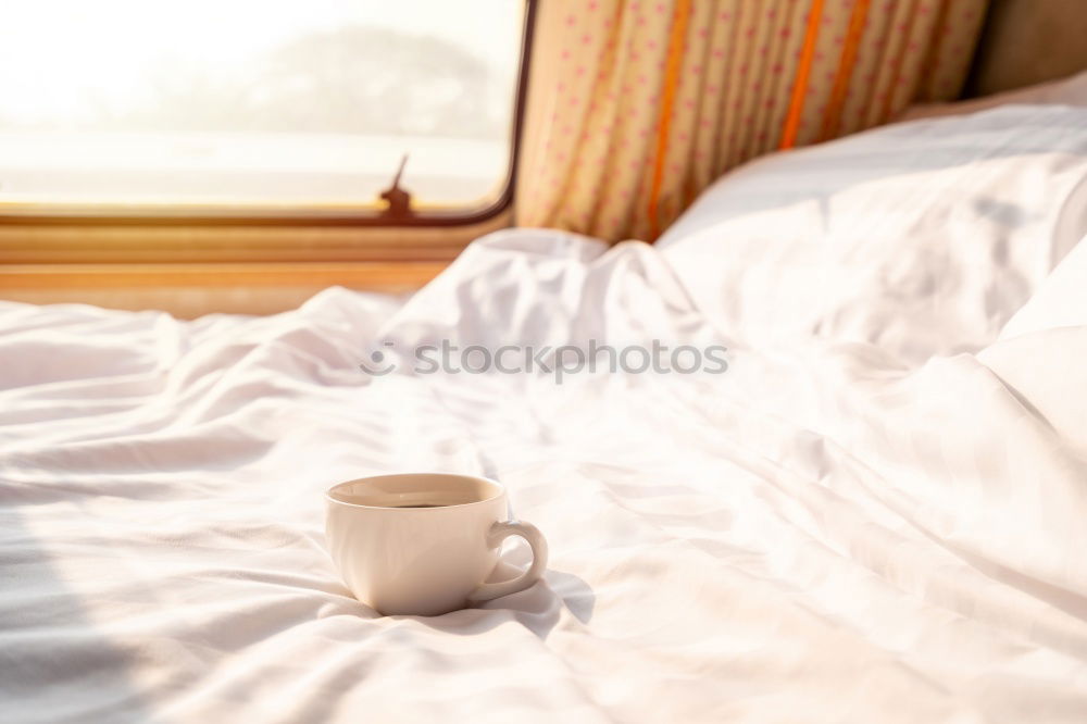 Similar – Image, Stock Photo Cup of coffee and spoon on wooden tray in bed on white sheets