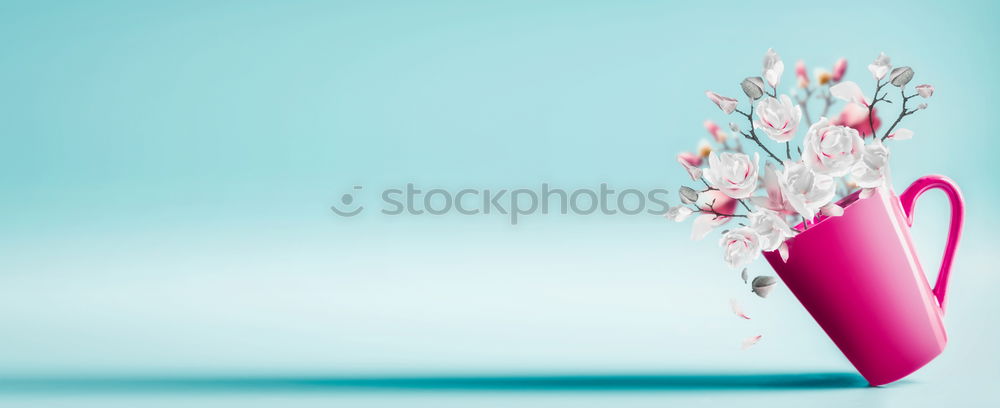 Pink cup with flying flowers