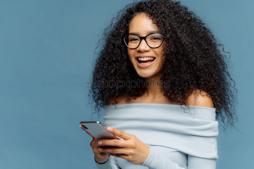 Similar – Image, Stock Photo Beautiful afro american woman using mobile in the street.