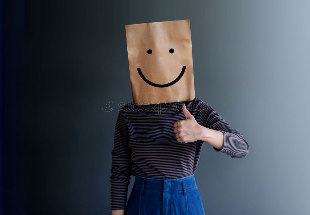 Similar – Person with paper bag on head pointing at camera