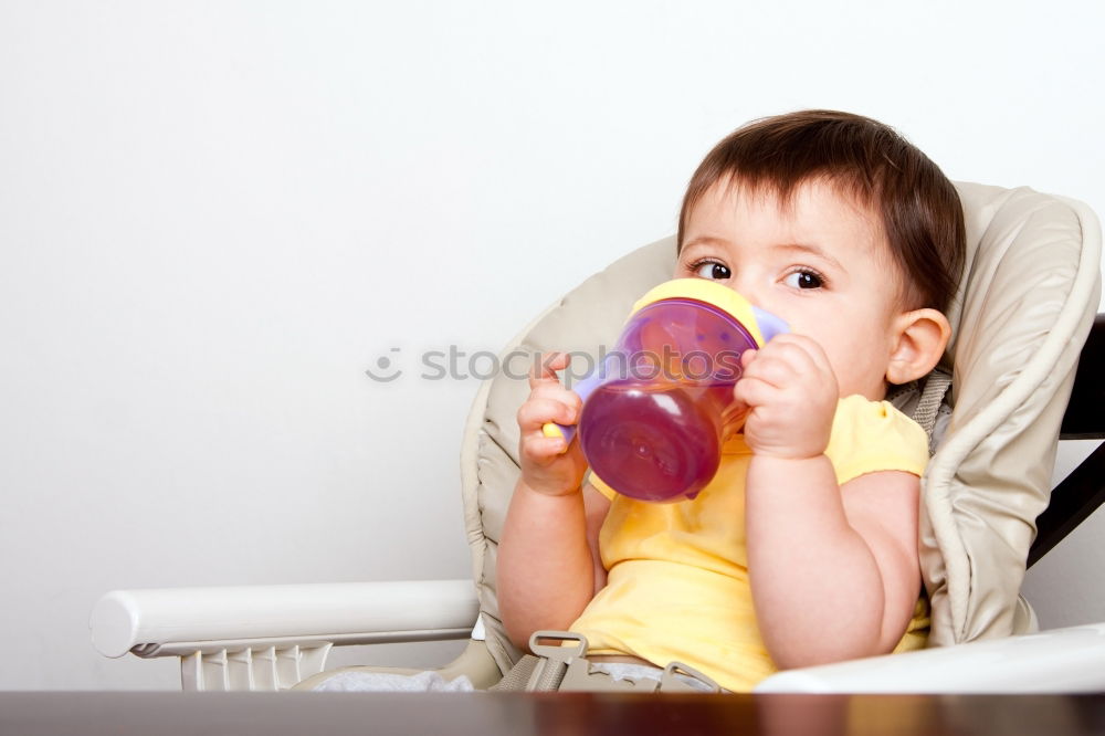 Similar – Baby toddler sits interested and curious in front of washing machine on the floor