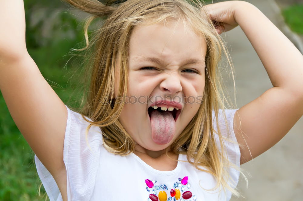 Similar – girl child tongue meadow