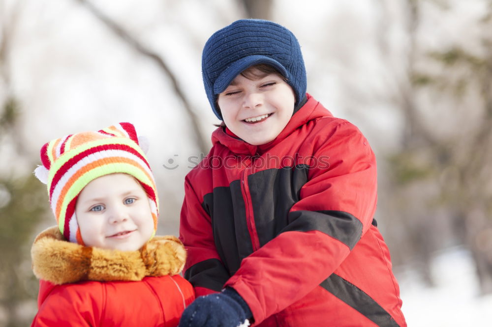 Similar – Two adorable young brothers outdoors in winter wrapped up warmly against the chill weather with the older boy cuddling his toddler sibling on his lap