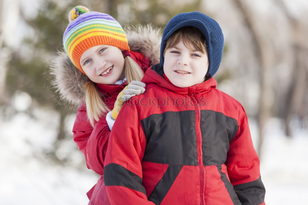 Similar – Two adorable young brothers outdoors in winter wrapped up warmly against the chill weather with the older boy cuddling his toddler sibling on his lap