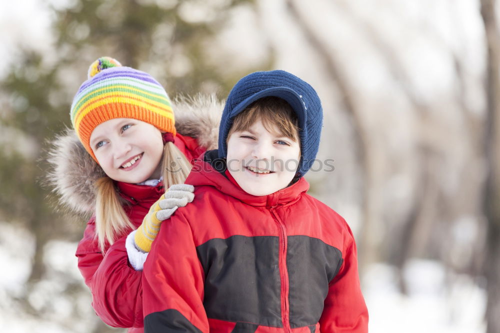 Similar – Two adorable young brothers outdoors in winter wrapped up warmly against the chill weather with the older boy cuddling his toddler sibling on his lap