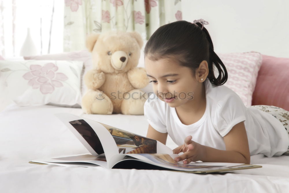 Image, Stock Photo Little girl doing homework on bed at home