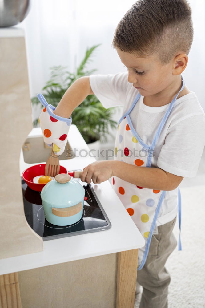 Similar – Boy in cook hat in kitchen