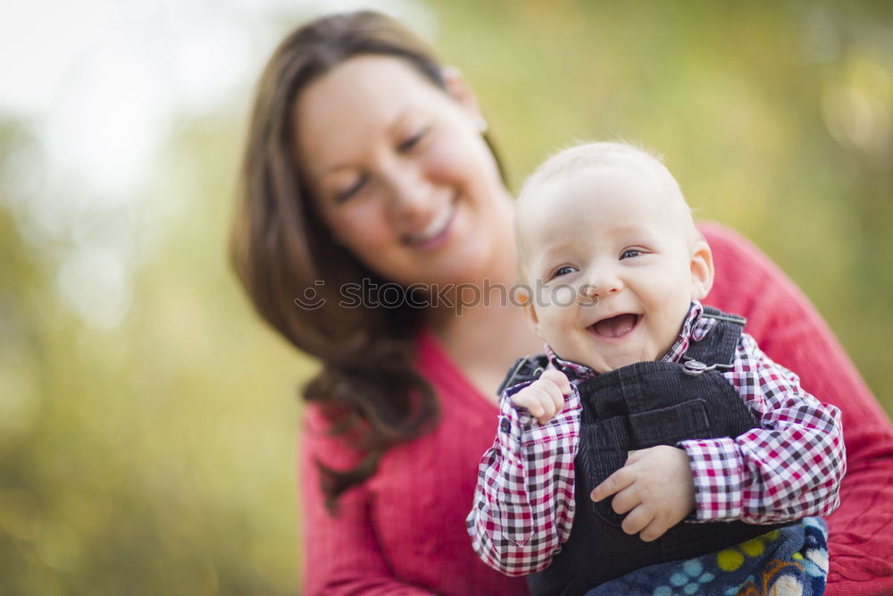 Similar – Image, Stock Photo Mother holding kid on hands in park