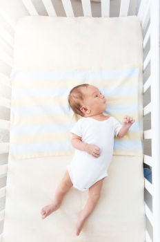 Cute Baby Girl Lying in the Crib