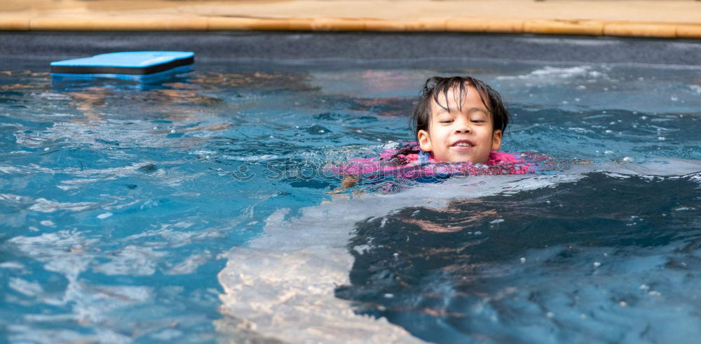 Similar – One little happy boy playing on the inflatable circle in swimming pool at the day time. Concept of friendly family.