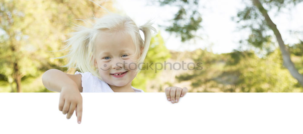 Similar – Mother holding kid on hands in park