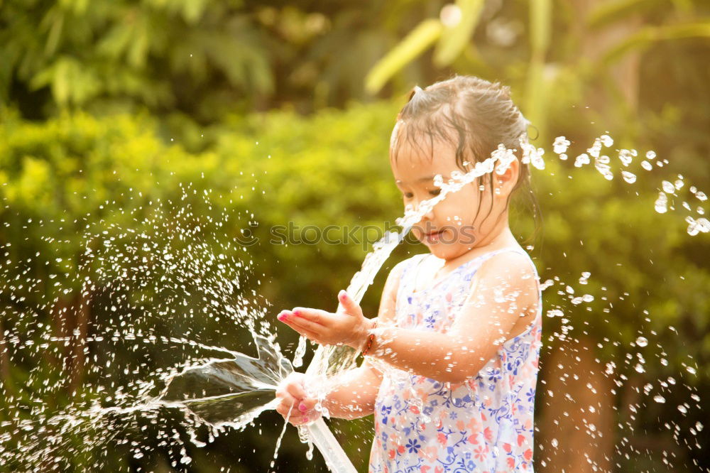 Similar – Sprinkler Fun Summer Water