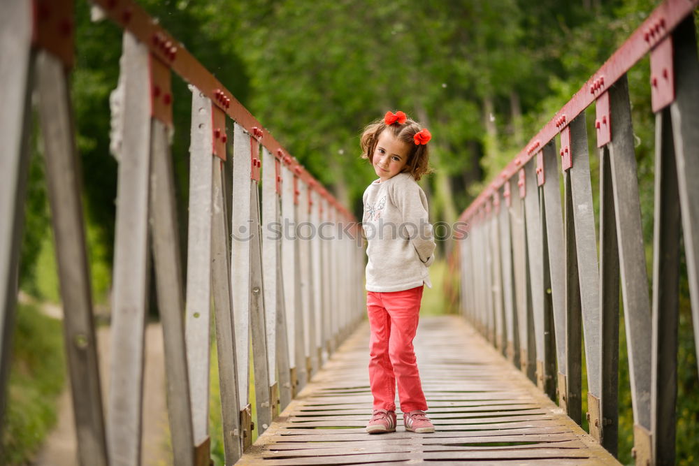 Similar – Image, Stock Photo Cute little girl having fun in a rural bridge