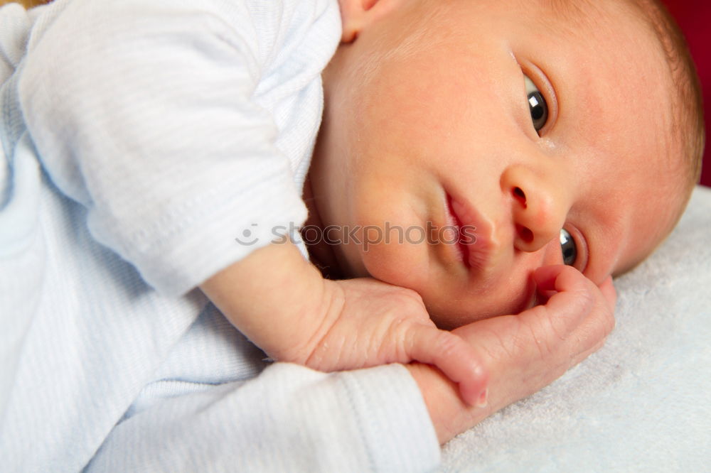 Similar – baby sleeping on his mother’s shoulder