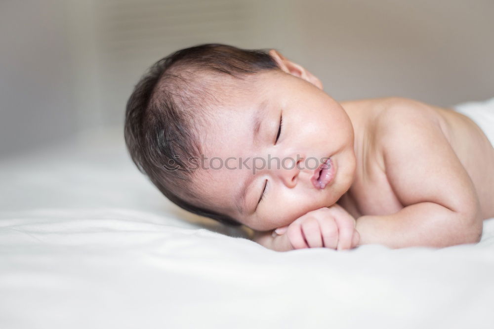 Similar – Baby sleeping on a blanket