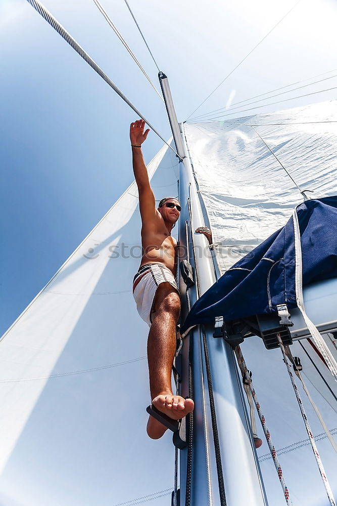 Athletic man balancing on gymnastic rings