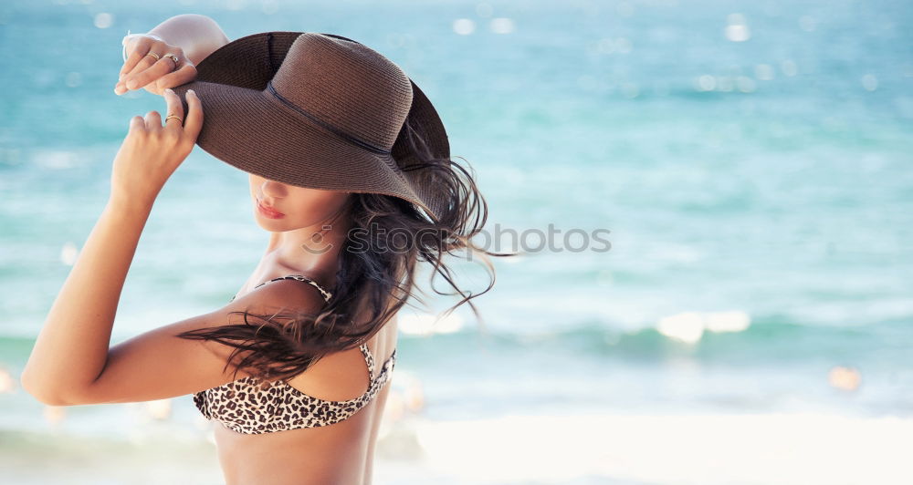 Similar – Young woman in a hat facing the beach