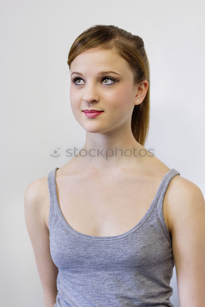 Similar – young woman looks up at the text space