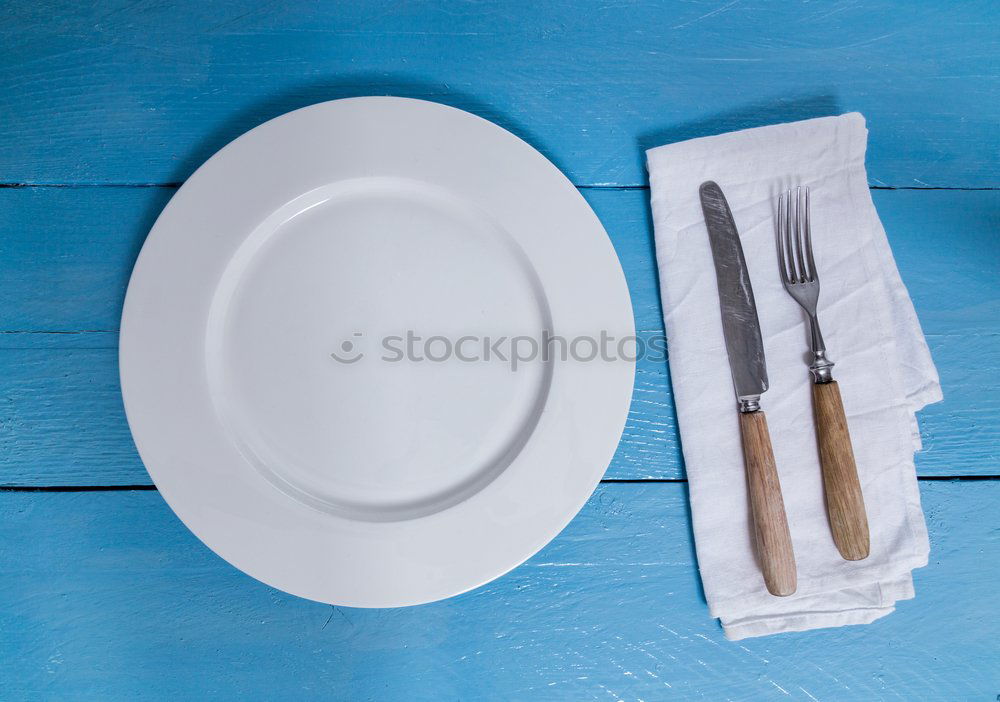 Similar – Disposable plastic cutlery on blue background. Top view