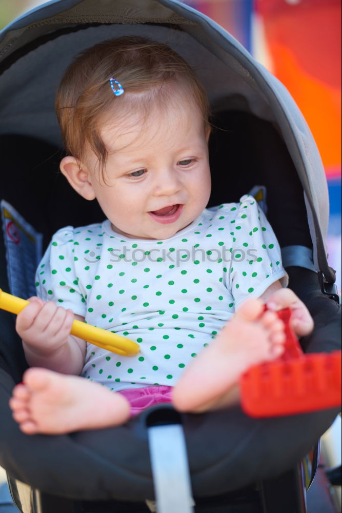 Similar – Young girl playing to driving a toy car