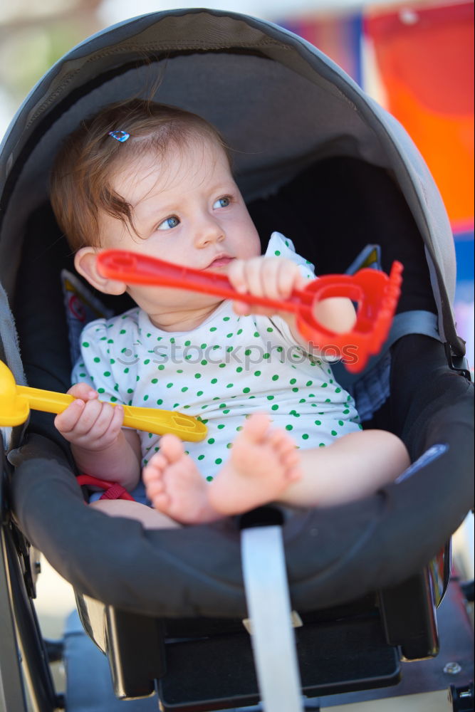 Image, Stock Photo Beautiful baby playing with her toys at carriage in a walk at park