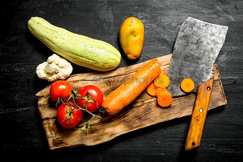 Similar – process of slicing fresh carrots on a chopping board