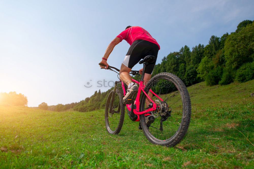 Similar – Young cyclist on the edge of a rock ready to jump