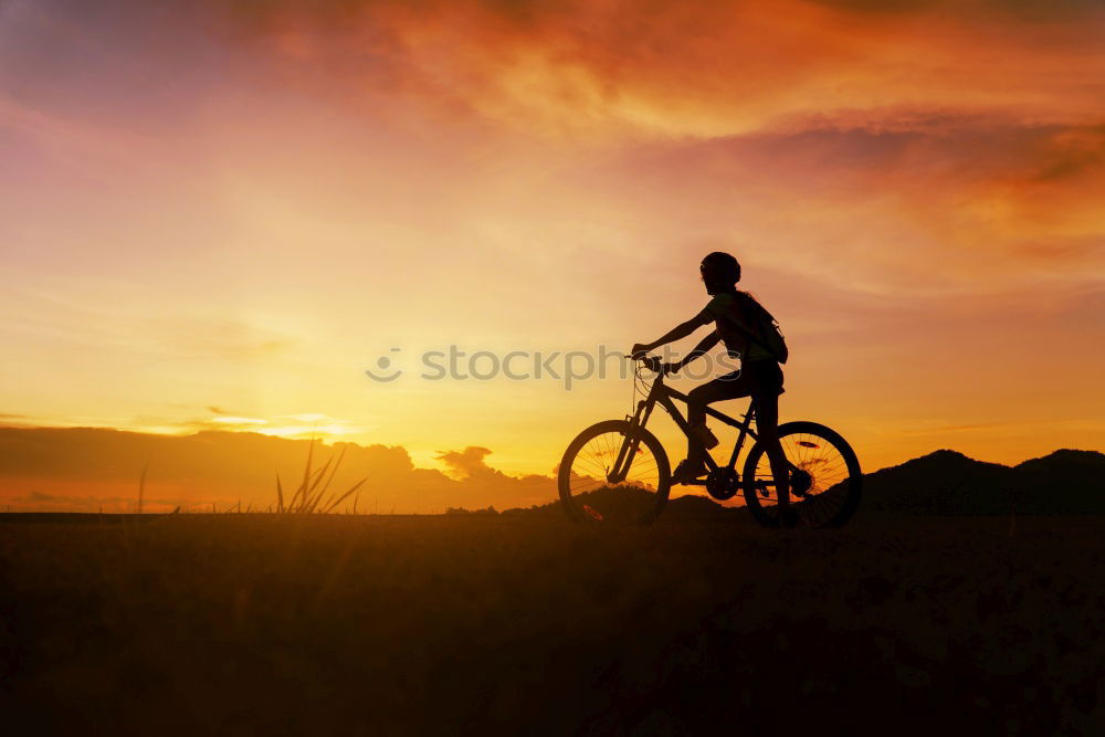 Similar – Image, Stock Photo unrecognizable Cyclist holding water canteen. sunset