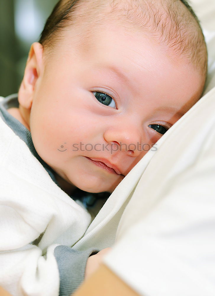 Similar – baby sleeping on his mother’s shoulder