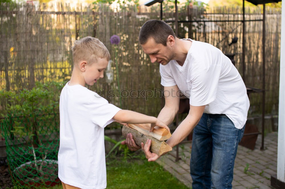 Similar – Image, Stock Photo Cheerful young man teaching his son to play mini golf