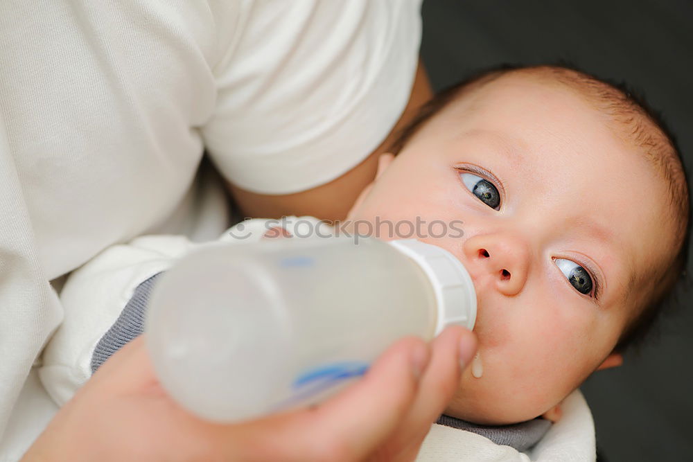 Similar – Baby taking feeding bottle