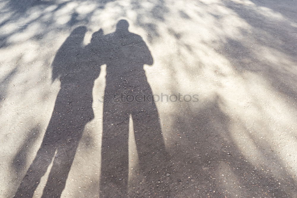 Similar – Schatten von Frau mit Tasche auf Stein