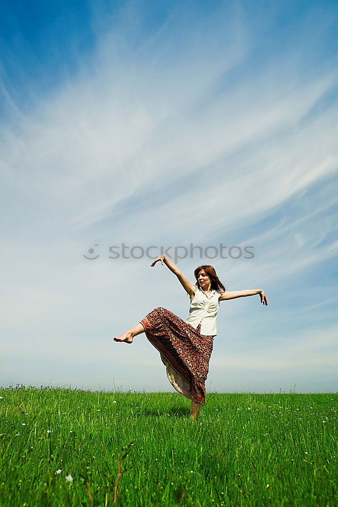 Similar – Image, Stock Photo A woman with a red cap stands in front of a wind turbine. Climate change. Alternative power generation. Renewable energy