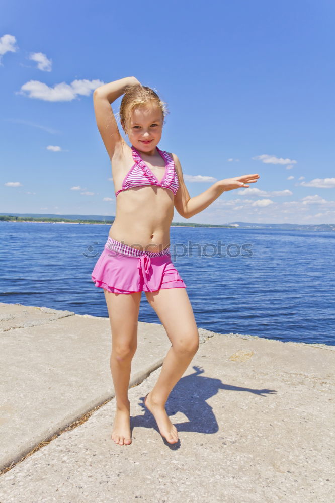 Similar – Image, Stock Photo Girl on the riverbank in pink swimsuit