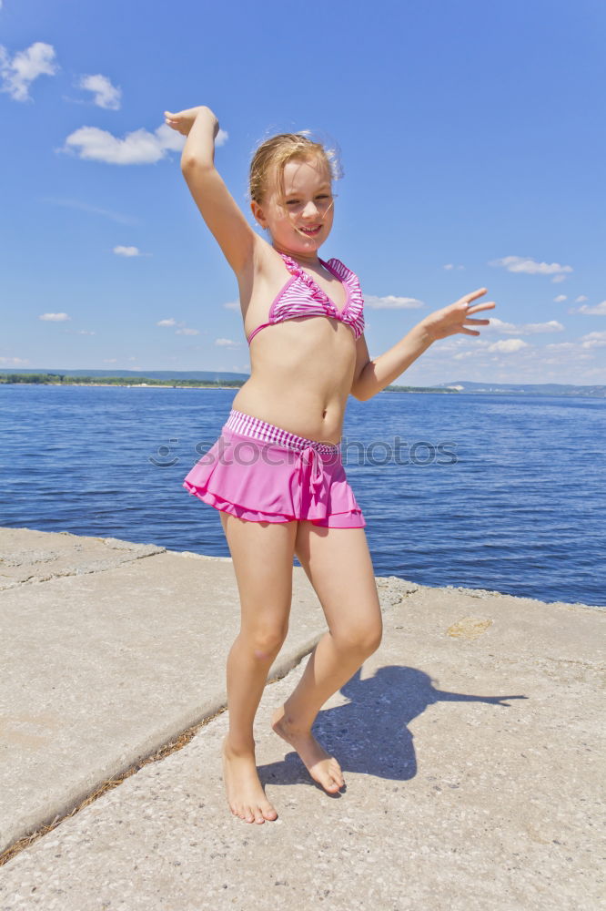 Image, Stock Photo Girl on the riverbank in pink swimsuit