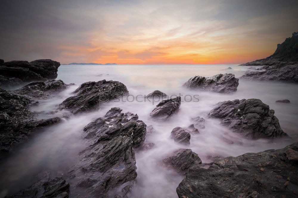 Similar – Rocks washed by the sea, with sky with sunset atmosphere