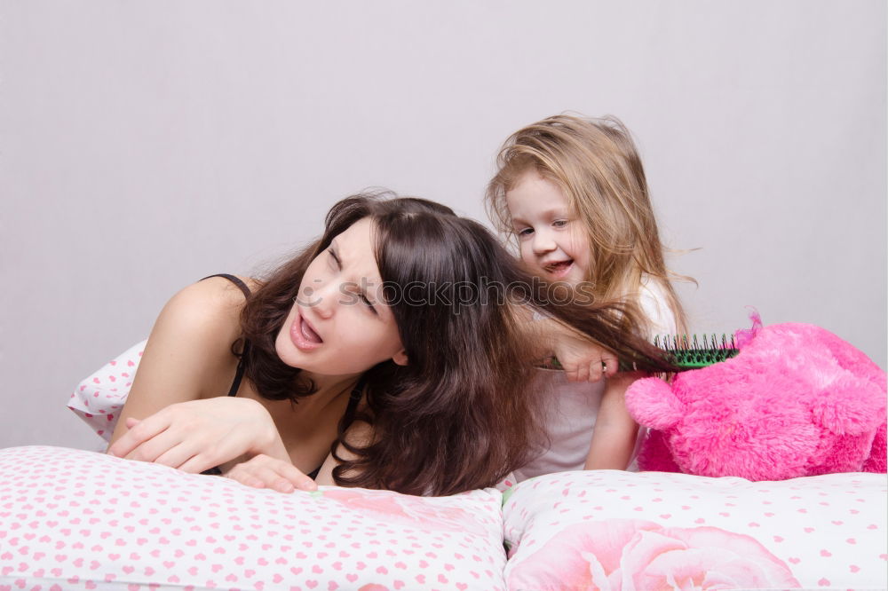 Similar – happy mother and child son fooling and playing in bed