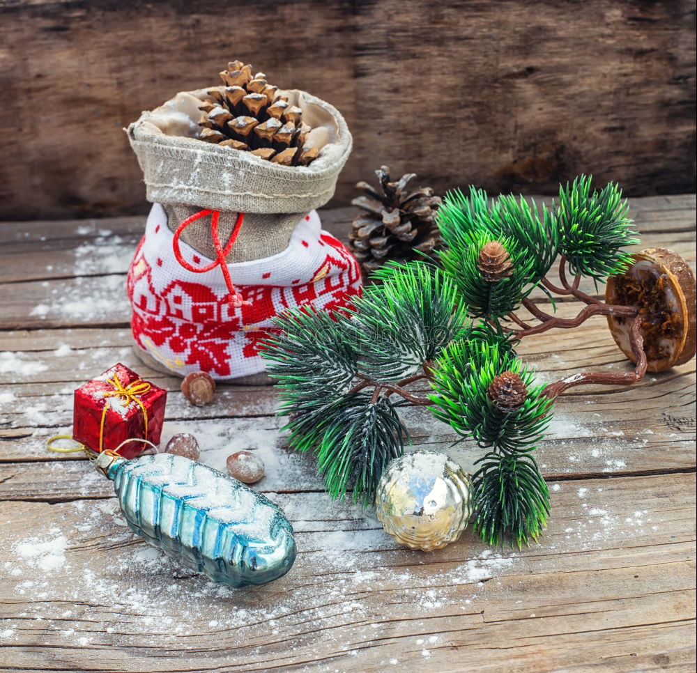 Woman arms doing christmas decoration in a wood table outdoors