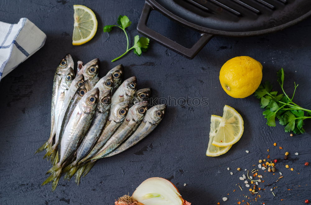 Similar – Image, Stock Photo Grilled sardines on baking tray with ingredients: lemon, garlic and herbs for tasty seafood eating. Cooking preparation of fishes