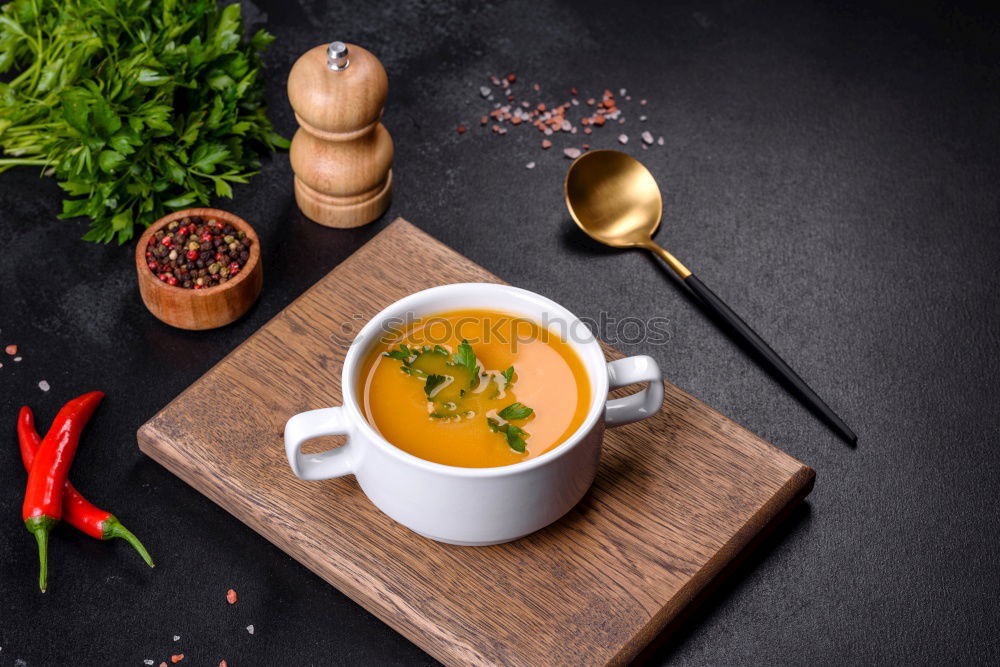 Similar – Pumpkin soup on the plate and salad