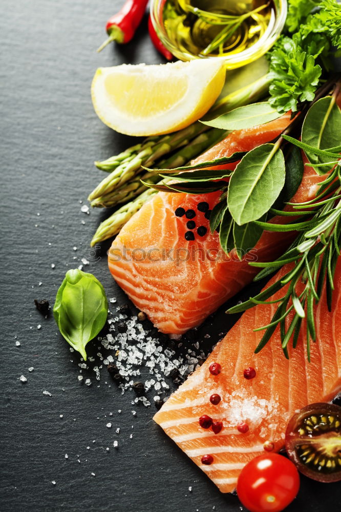 Similar – salmon, fresh herbs, oil and spoon on old wooden table